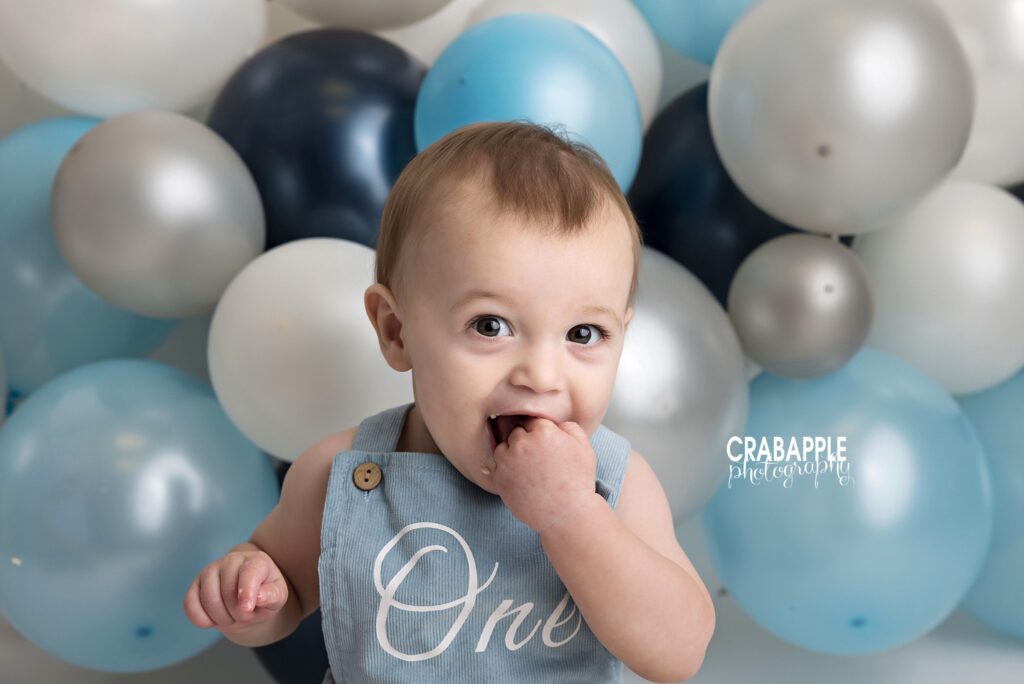 Baby boy during his 1-year cake smash Close-up of baby boy during his 1-year cake smash session in Andover MA