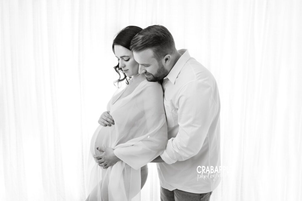 Black and white maternity couple portrait Black and white maternity portrait of an expecting couple together in the studio