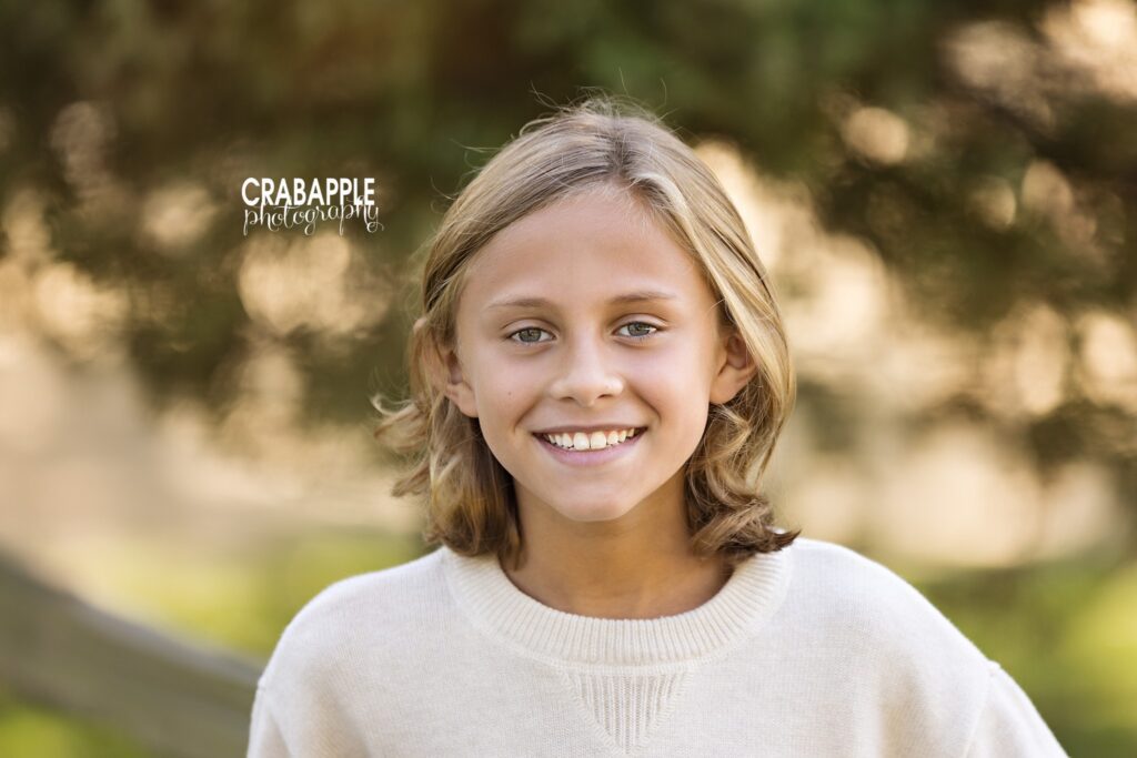 Teenage boy wears cream sweater for fall family portraits
