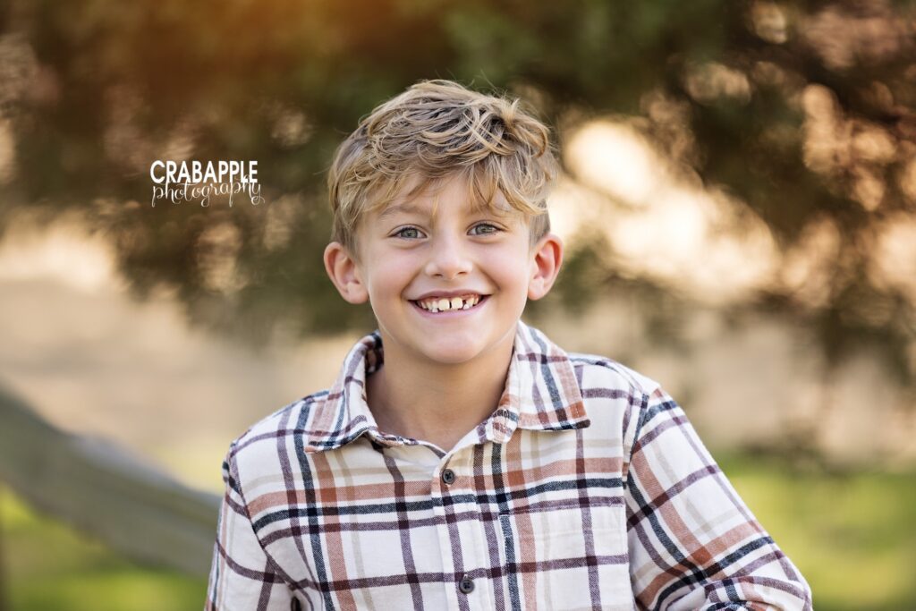 Young boy wears a flannel shirt during fall family portraits in Medford MA