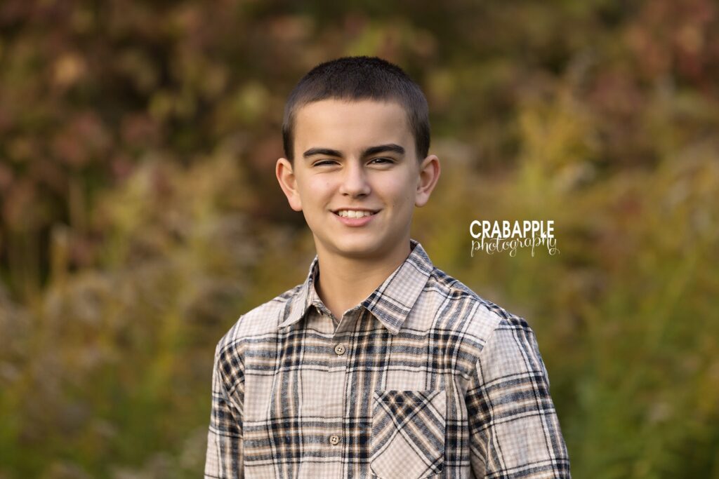 Close portrait of a boy in front of the autumn foliage at Ipswich River Park
