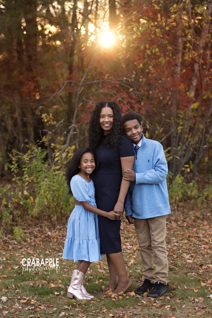 Mother standing with two children during a fall family photo session at Ipswich River Park