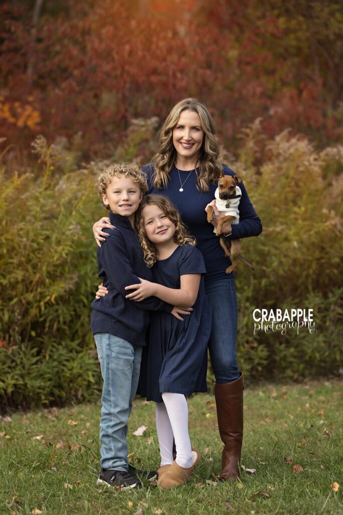 Mother stands with two children and pet dog during North Reading MA fall family portrait session