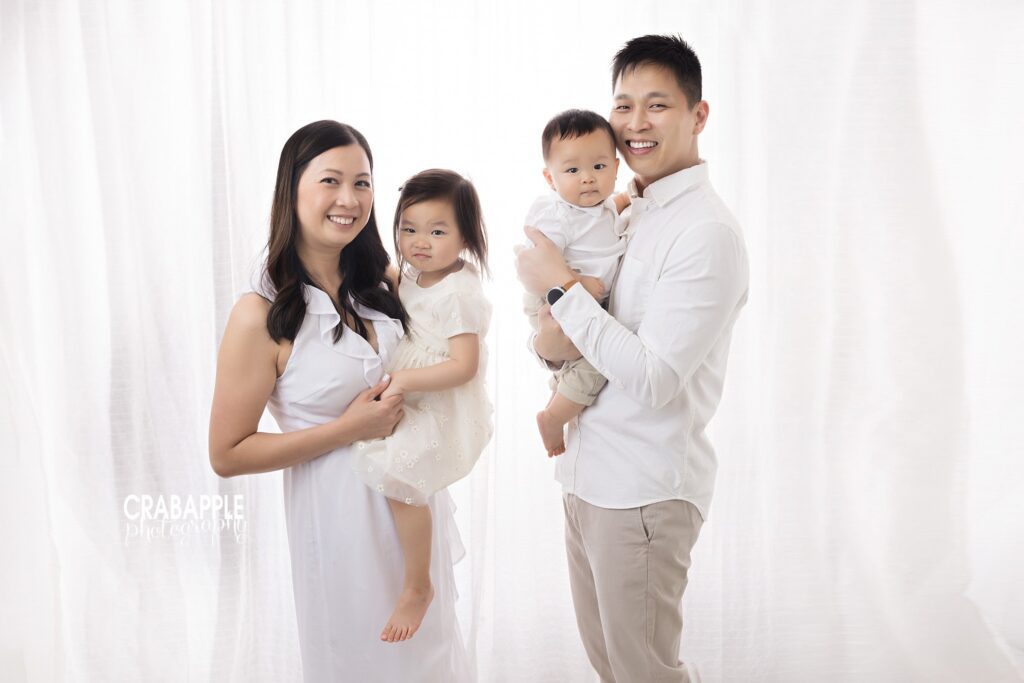 Parents and two children together during a 10-month baby photography session