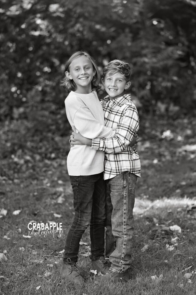 Black and white sibling hug Two siblings hugging during a black and white outdoor portrait in Medford