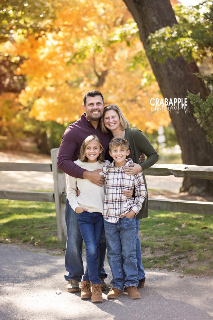 Parents embracing their children during an outdoor fall photo session in Medford