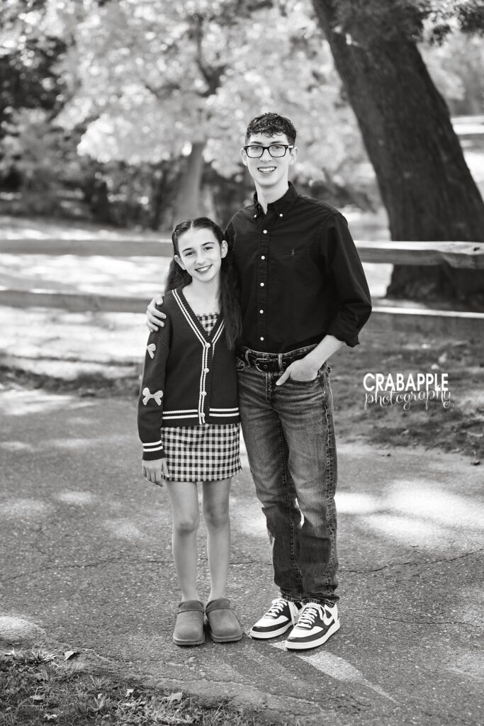 Black and white sibling portrait Older brother and younger sister standing together for a black and white portrait in a Medford park