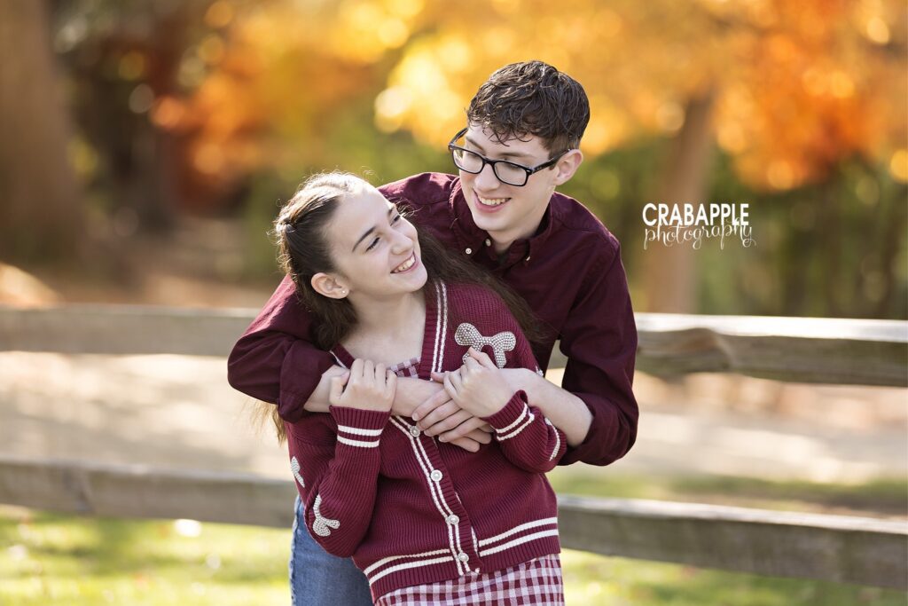 Playful sibling fall portrait Two siblings laughing and interacting during fall portraits in Medford