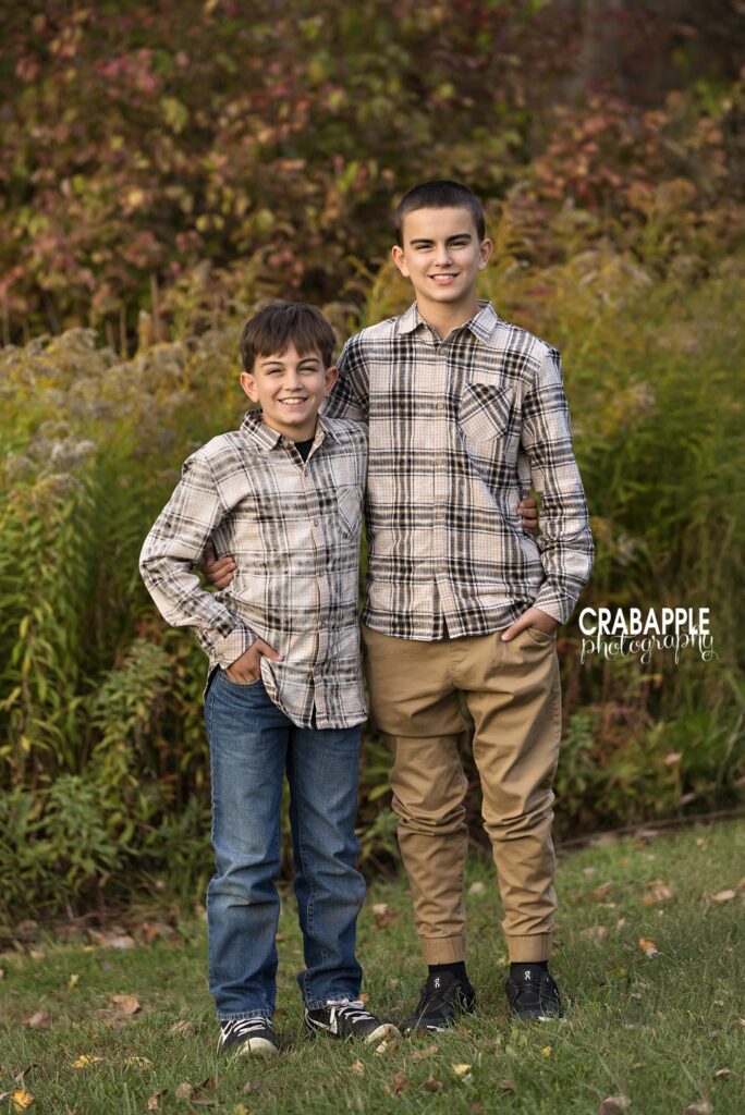 Brothers during fall family photos Two brothers standing together during an outdoor fall photo session in North Reading