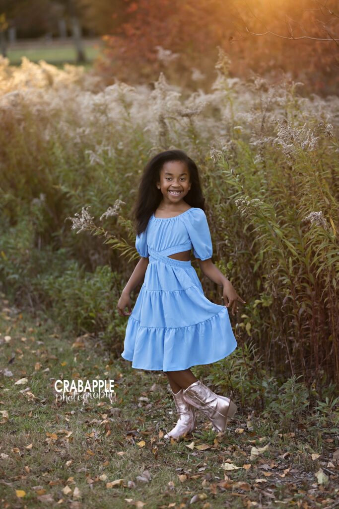 Young girl standing among the autumn foliage at Ipswich River Park