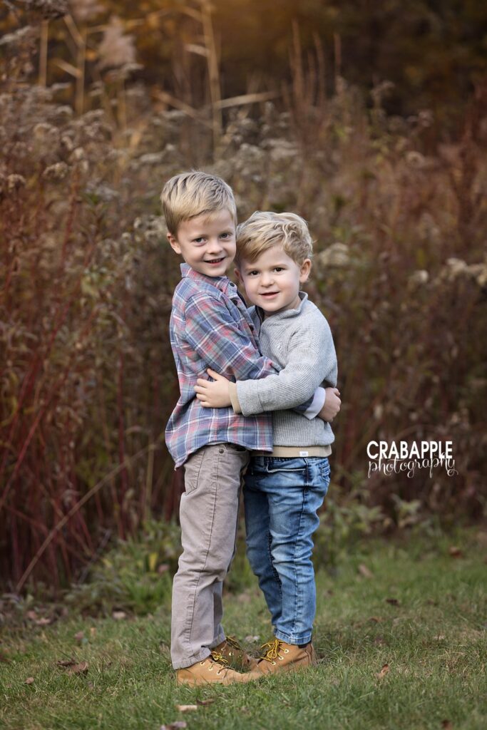 Brothers hugging during fall photo Two brothers hugging during fall sibling photos at Ipswich River Park in North Reading