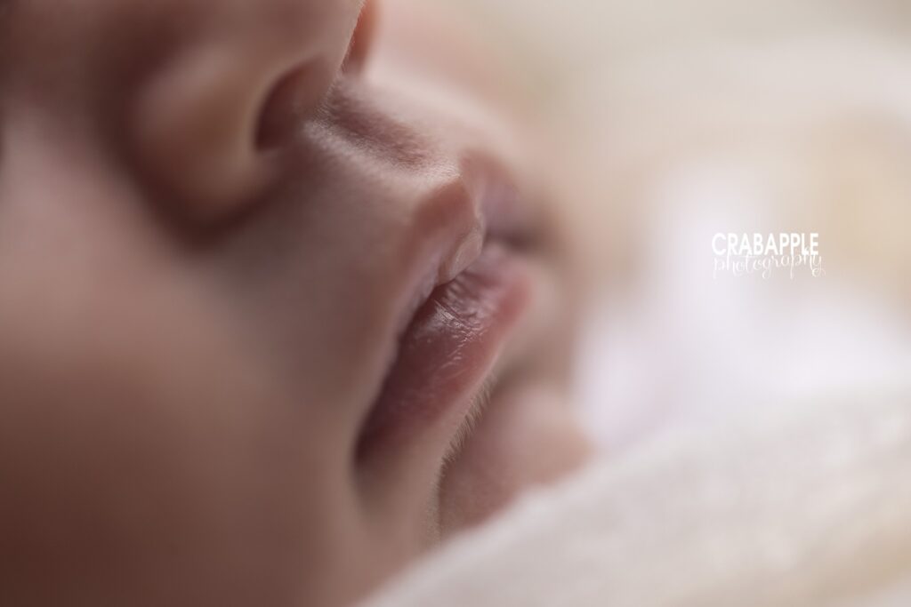 Close-up detail of a newborn girl's tiny mouth	